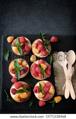 Delicious summer tartlets with raspberries and yoghurt. Yellow and red raspberries. Healthy dessert. Keto dessert.