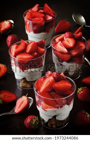 Strawberry desserts in cups. Summer snack strawberry yogurt granola.
