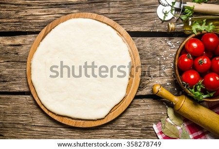Similar – Image, Stock Photo Dough rolled out on a green background. Homemade pie crust and rolling pin. Baking concept
