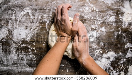 Similar – Image, Stock Photo A dough is kneaded on a kitchen table and dusted with flour