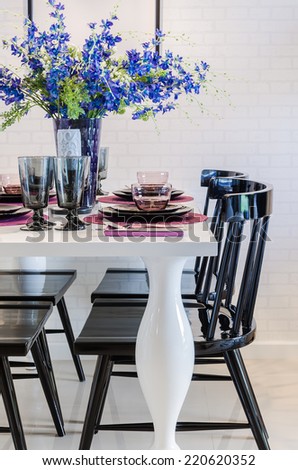 flower on white dinning table with black chair in dinning room