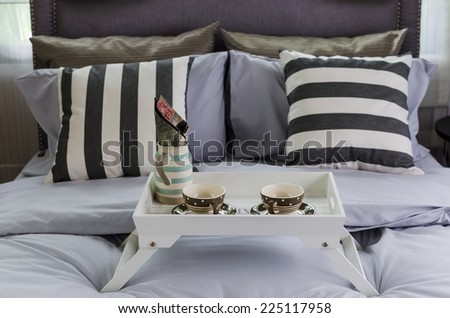 wooden white tray of tea set on bed