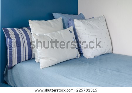 pillows on blue bed in kid bedroom at home