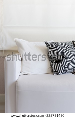 white sofa with black and white pillows in living room