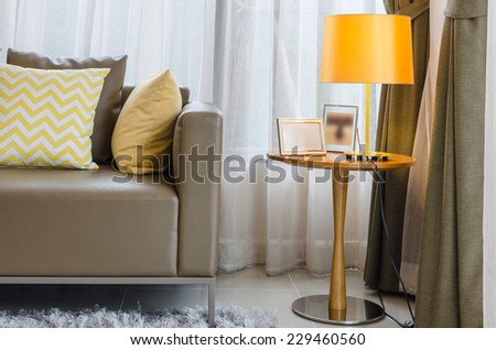 modern living room with yellow lamp on round table