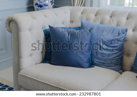 blue pillows on white sofa in luxury living room