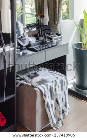 black dressing table with brown chair at home