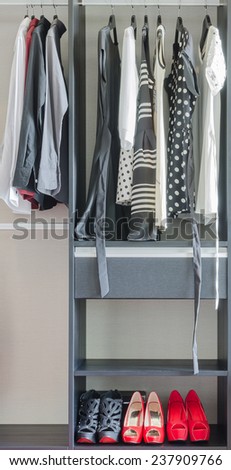 row of black and white dress with shoes in wardrobe at home