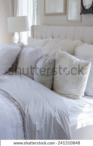 white and grey pillows on bed in luxury bedroom