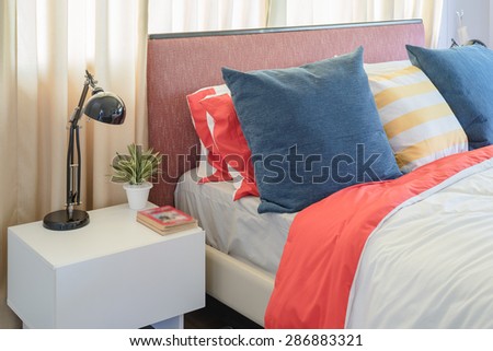 colorful bedroom with black lamp on white table at home