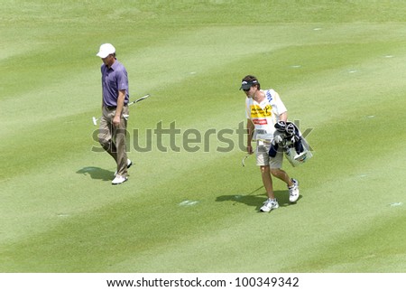 KUALA LUMPUR - APRIL 15: Richard Green of Australia walking with his caddy to 18th holes during final round of Maybank Malaysian Open 2012 at Kuala Lumpur Golf & Country Club on April 15, 2012