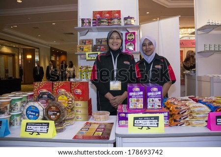 KUALA LUMPUR, MALAYSIA-JUNE 6,2013: Noraini(L), cookies women entrepreneurs  from Malaysia posing for photograph in exhibition of Global Summit of Women 2013 in Kuala Lumpur, Malaysia on June 6, 2013