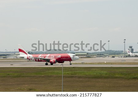 SEPANG, MALAYSIA - AUGT 4: Airbus A320 registered with number 9M-AHR owned by Air Asia ready to take off from Kuala Lumpur International Air Port, Sepang, Malaysia on August 4, 2014.
