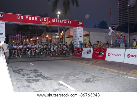 KUALA LUMPUR, MALAYSIA-OCTOBER 16: Riders at the starting line during OCBC Cycle Malaysia 2011 in Kuala Lumpur, Malaysia on October 16, 2011.