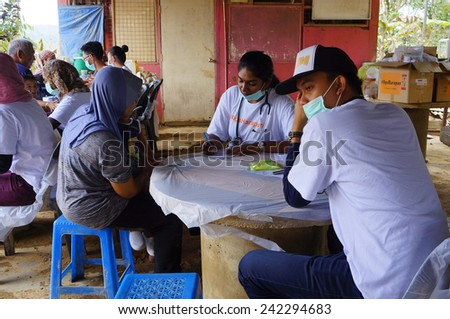 TANAH MERAH, KELANTAN - JANUARY 2: Medical team from OPS Harapan Mobile Clinic provide relief to flood victims in Kusial Baru village, Tanah Merah, Kelantan on January 2, 2015.