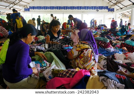 GUA MUSANG, KELANTAN - DECEMBER 31: Flood victims choosing clothes donated by people in evacuation center, Gua Musang aftermath the worst flood that ever hit Kelantan, Malaysia on December 31, 2014