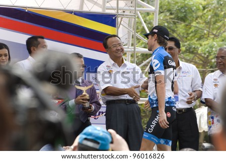 PUTRAJAYA-FEBRUARY 24: National Sports Council (NSC) director general Datuk Zolkples Embong congratulates David Zabriskie (USA) during Tour de Langkawi 2012 in Putrajaya, Malaysia on February 24, 2012.