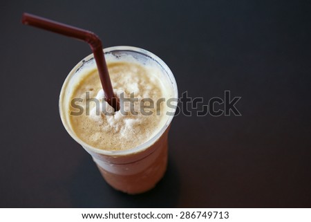 Iced coffee smoothie on black table