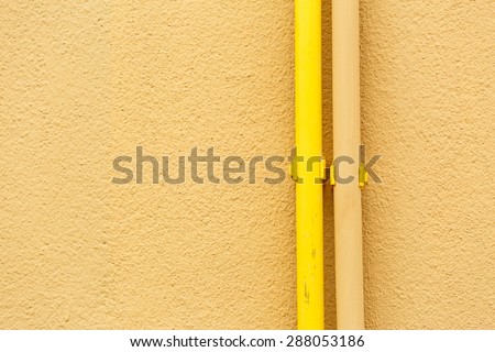 Yellow PVC pipes  on the yellow wall