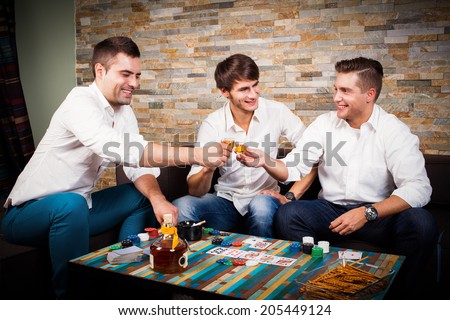 friends playing poker and drinking rum shots