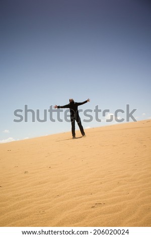 man standing alone on a dune
