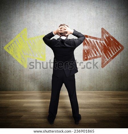 businessman has to decide which way to go