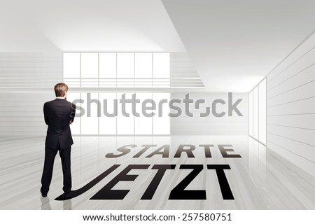 businessman in an empty white room with the slogan 