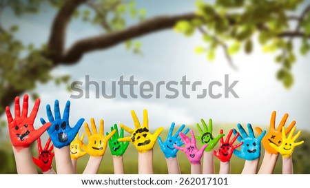 colorful painted hands in front of a spring scene