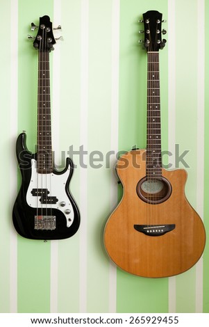 acoustic and electro guitar on the wall