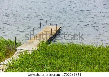 Similar – Foto Bild Bootssteg oder Badesteg aus schönem alten Holz im Sommer bei Sonnenschein am Alpsee in Schwangau bei Füssen im Allgäu im Freistaat Bayern