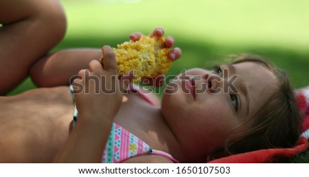 Similar – Image, Stock Photo Peaceful child daydreaming while lying on horse