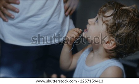 Similar – Image, Stock Photo Child flossing face and tiring milk tooth to pull out