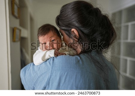 Similar – Image, Stock Photo Lovely and curious newborn lying down in her little bed