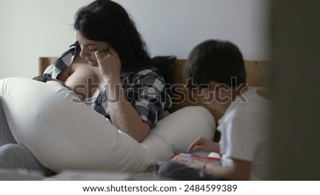 Similar – Image, Stock Photo Mother nursing while read a book