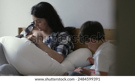 Similar – Image, Stock Photo Mother nursing while read a book