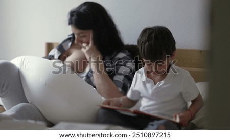 Similar – Image, Stock Photo Mother nursing while read a book