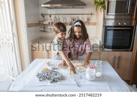 Similar – Image, Stock Photo Siblings kneading dough in kitchen