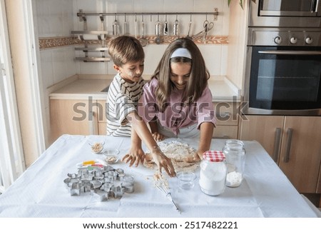 Similar – Image, Stock Photo Siblings kneading dough in kitchen