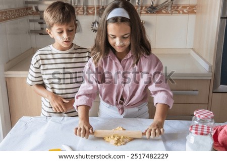 Similar – Image, Stock Photo Siblings kneading dough in kitchen