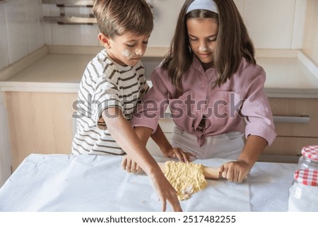 Similar – Image, Stock Photo Siblings kneading dough in kitchen