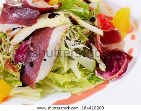 Salad with smoked duck breast close up