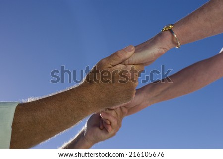 Mature couple holding hands, close-up