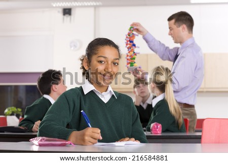 Students watching biology teacher demonstrating a DNA model