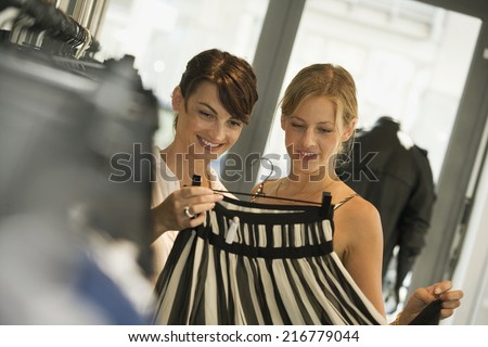 Women looking at a skirt at a boutique.