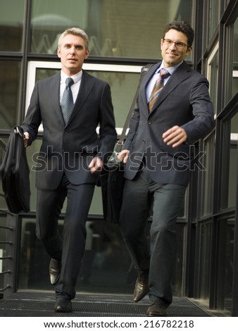 Two businessmen leaving office.