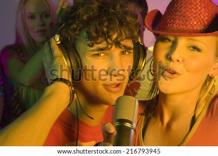 Close-up of a young couple singing in a nightclub