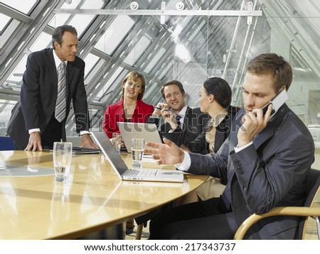 Five business executives in a board room