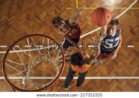High angle view of three young men playing basketball