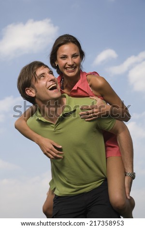 Man giving woman piggyback ride