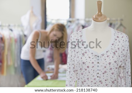 Fashion Designer Sewing Fabric In Studio